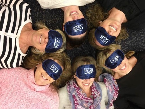 Six people with sleeping masks with the UCSB logo